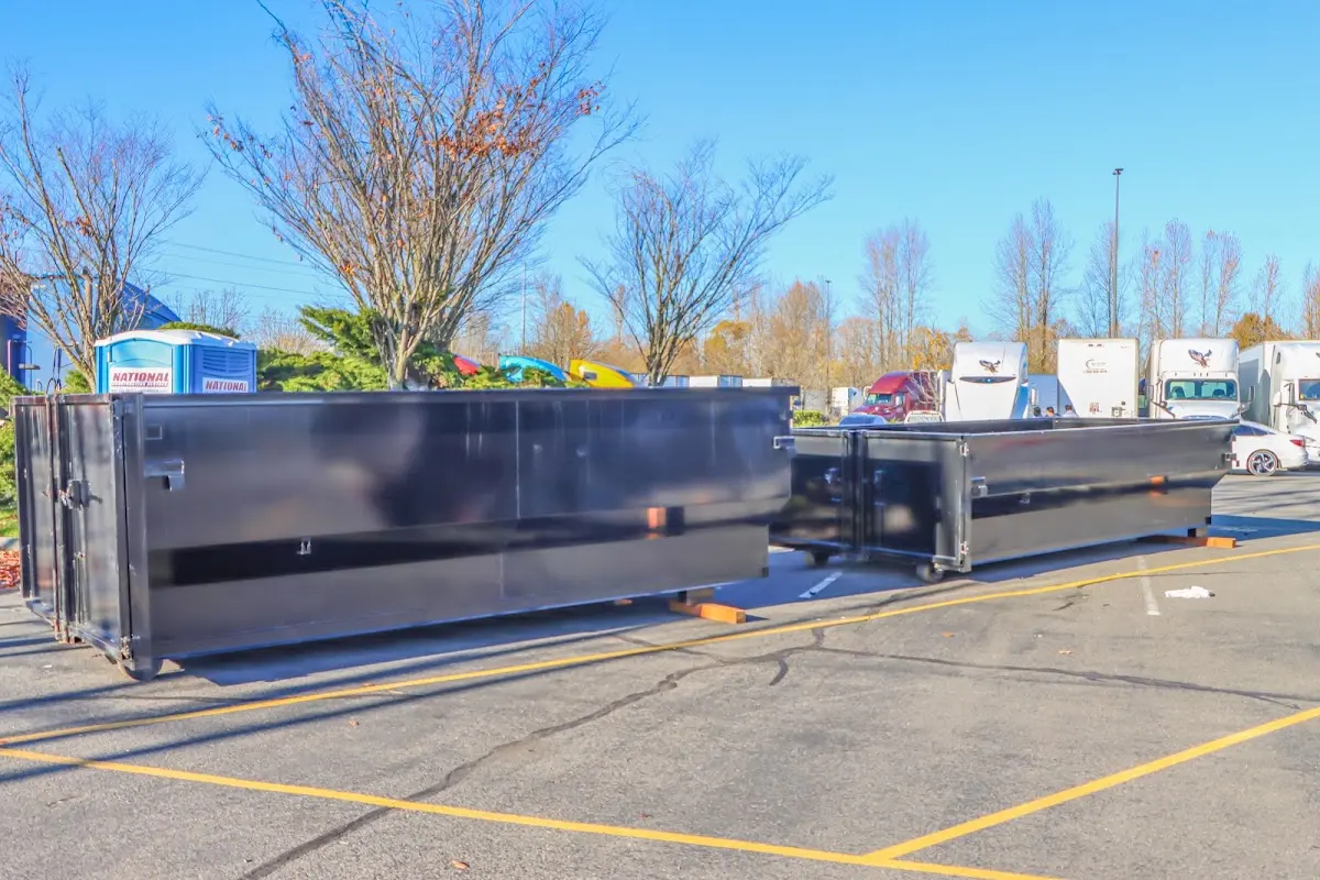 Professional dumpster rental service with roll-off container on residential driveway in Oradell